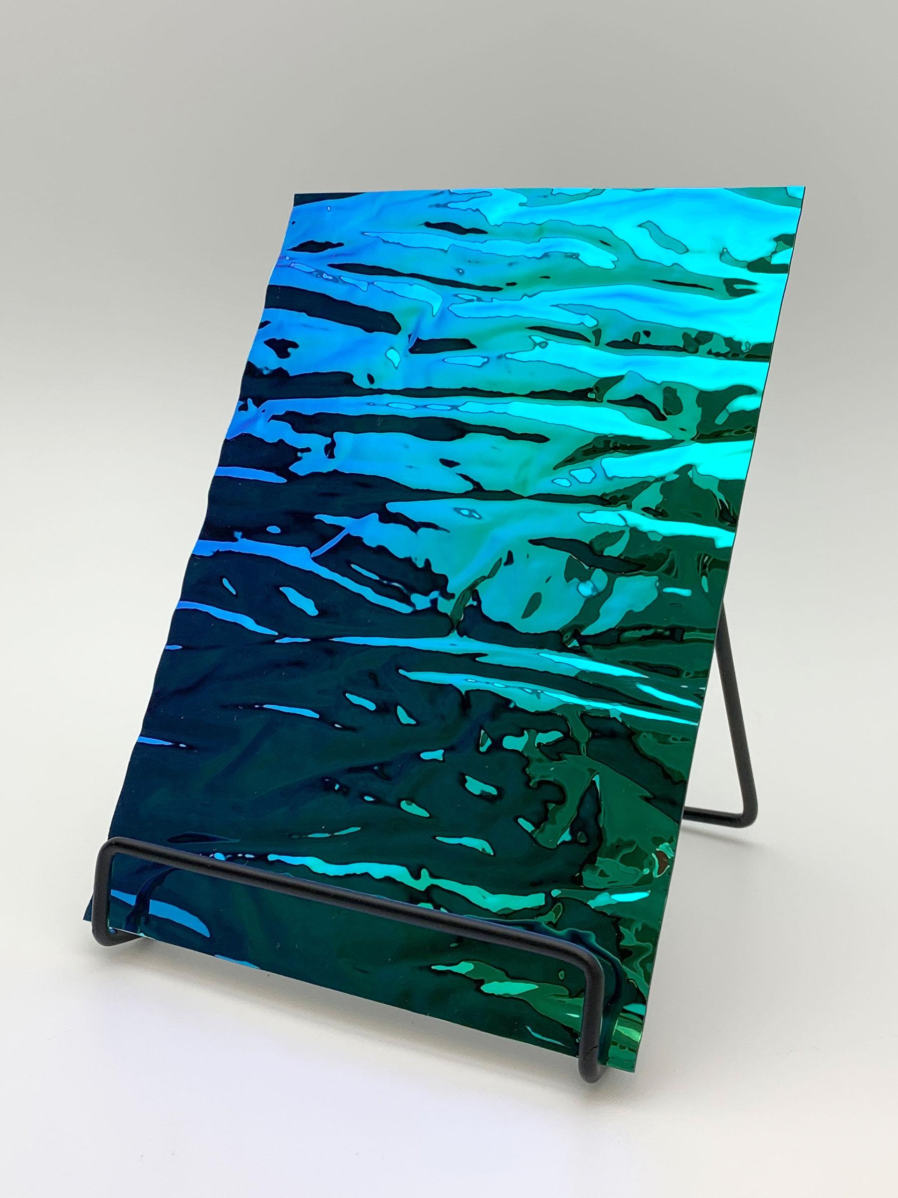 Elements Texture Aqua Distortion real material sample - standing panel with a wavy, colour-shifting blue-to-green mirror surface