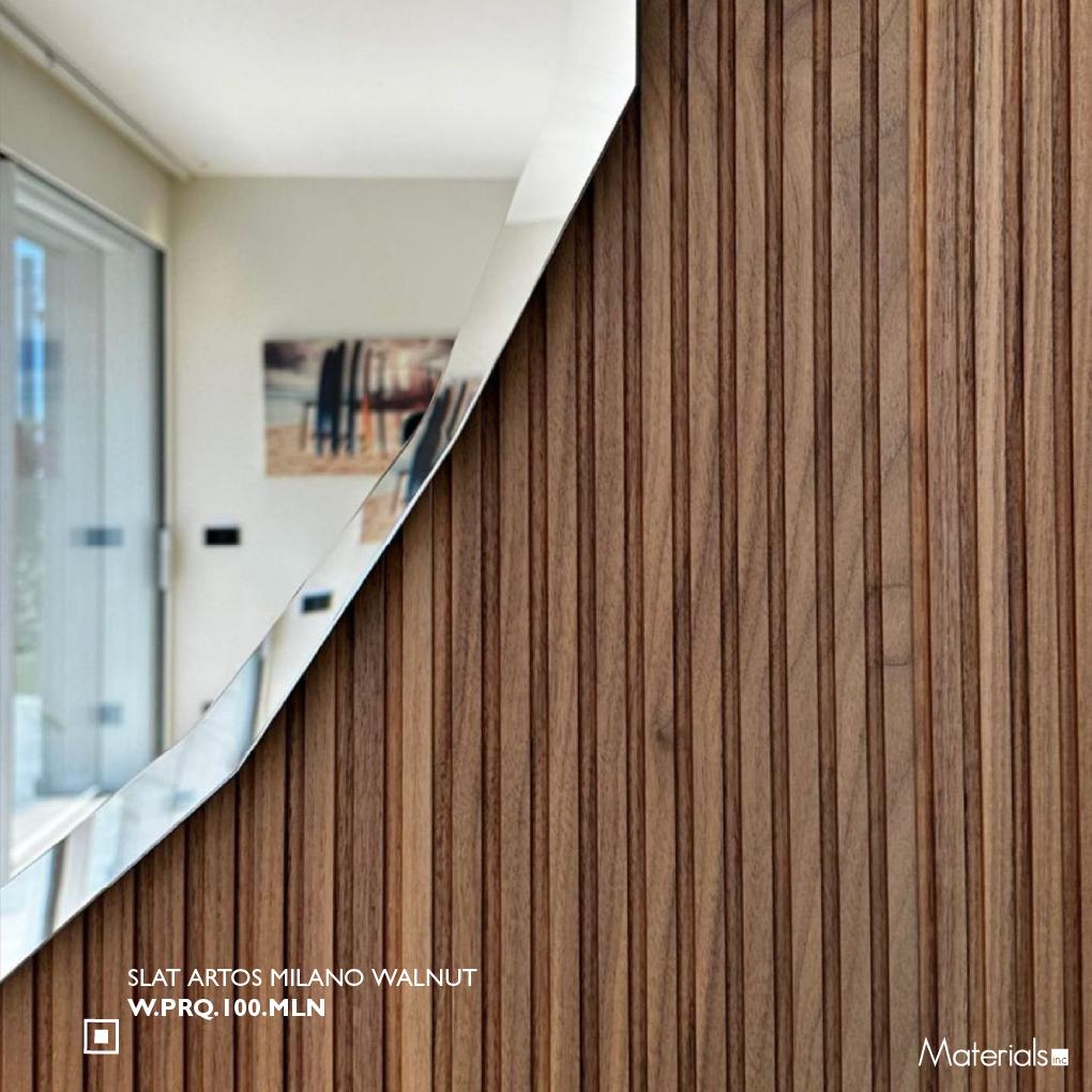 Close-up of Slat Artos Milano Walnut fluted wall panel texture beside a glass door