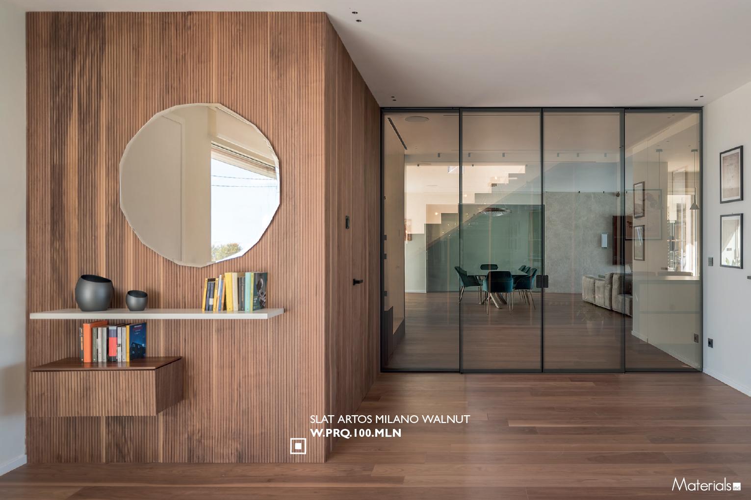 Slat Artos Milano Walnut fluted wall panel installed in an entryway behind a round mirror and floating console