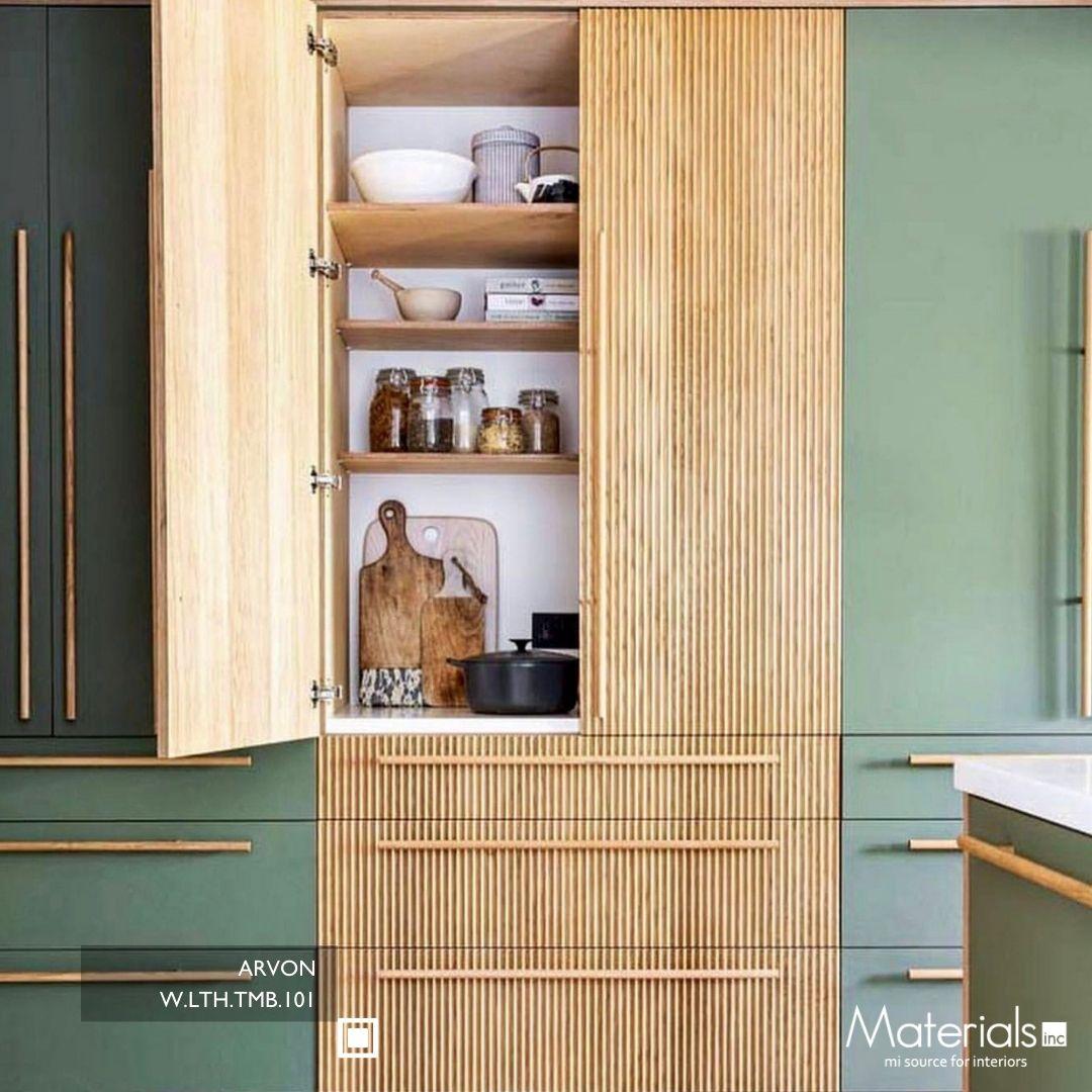 Tambora Arvon milled wood panel on an open pantry cabinet door in a sage green kitchen