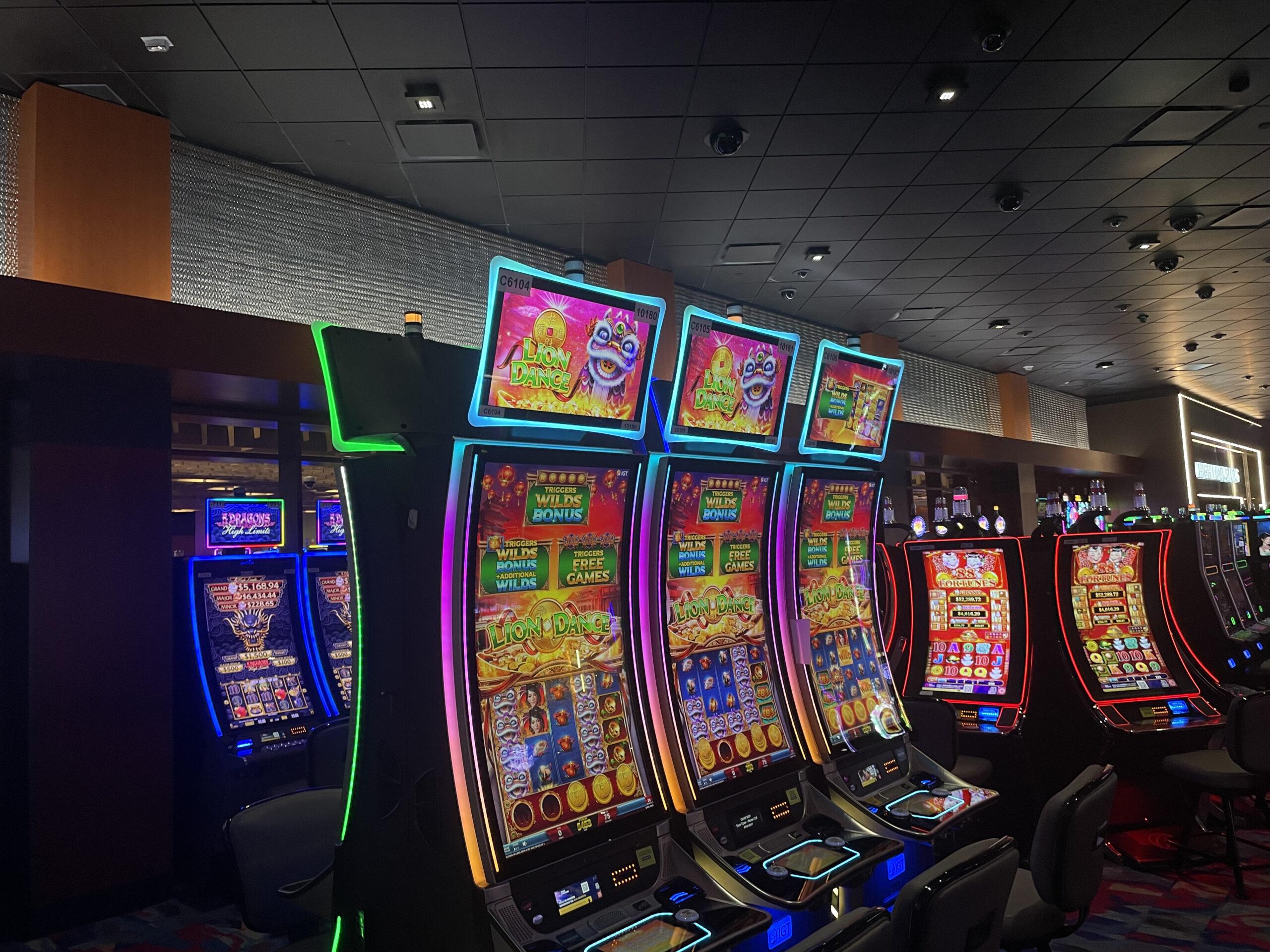 Luminous honeycomb mesh panel trim along the ceiling perimeter of a casino gaming floor