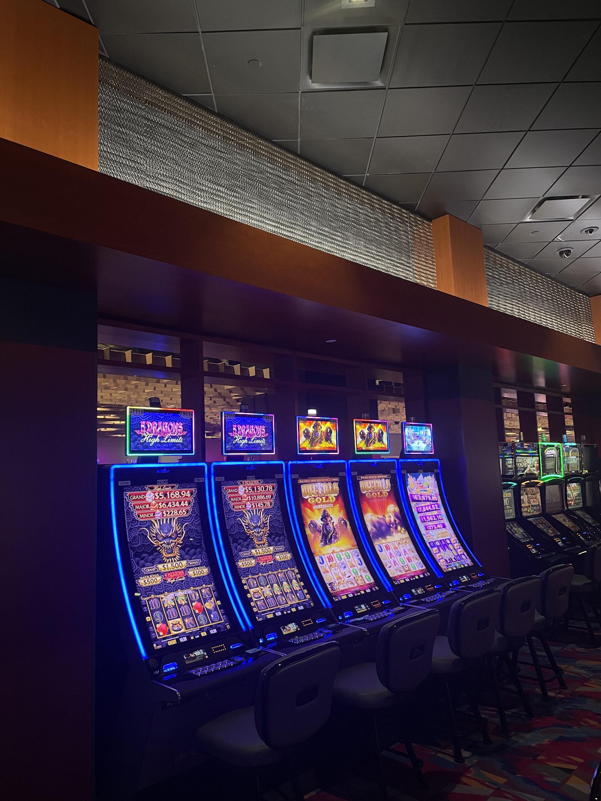 Luminous honeycomb mesh panel trim above a bank of slot machines