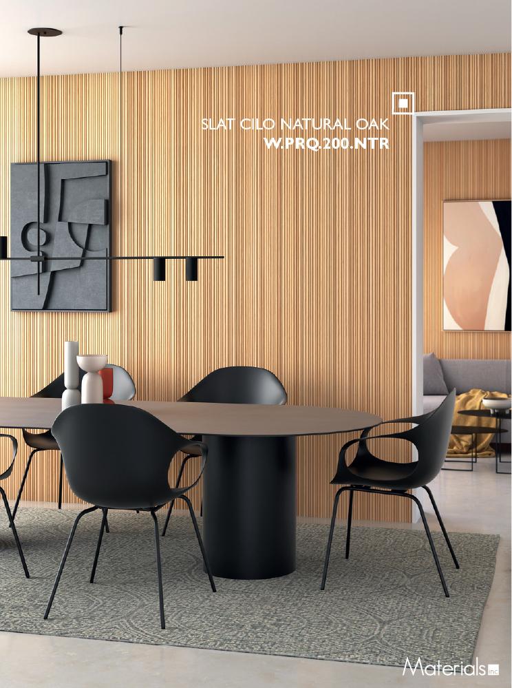 Slat Cilo Natural Oak fluted wall panel installed behind a dining table with black chairs