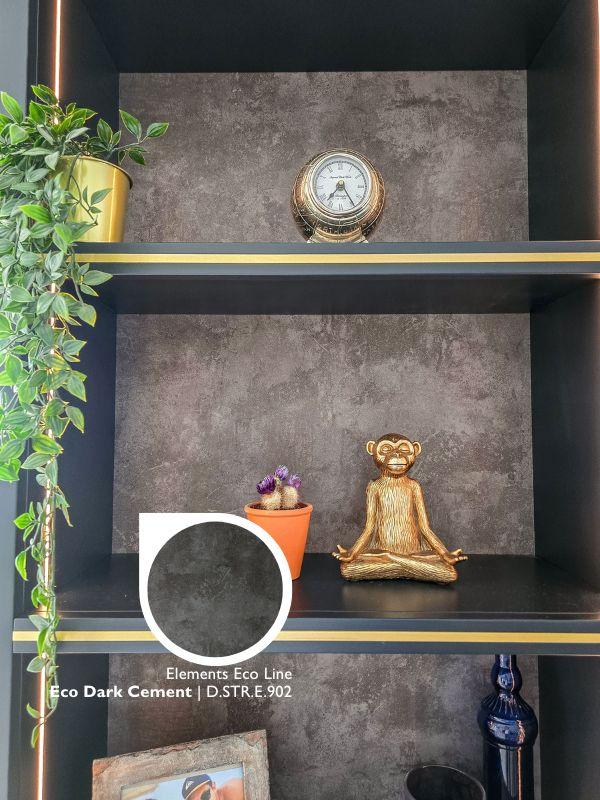 Close-up of Elements Eco Dark Cement laminate shelving with a gold monkey figurine