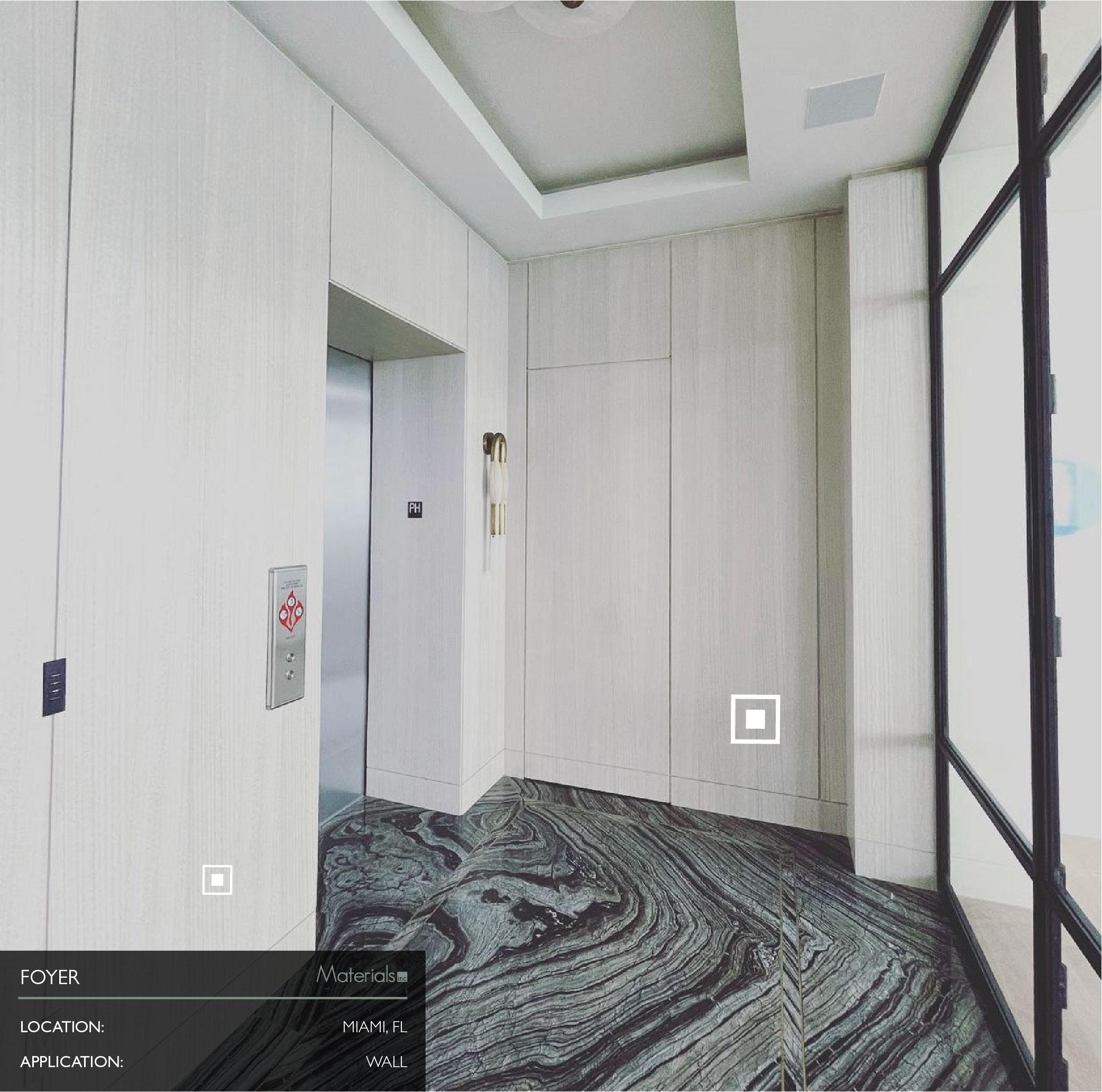 Dye-A-Log wood veneer wall paneling in a residential foyer beside an elevator