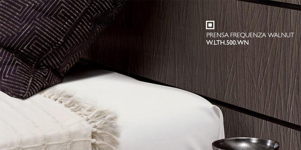 Prensa Frequenza Walnut embossed wood panel behind a bedroom headboard