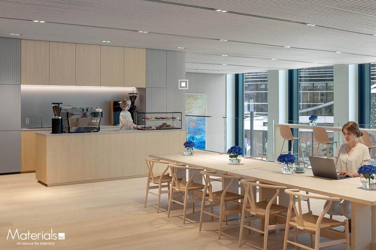 Aria Fluted Idro concrete panel cladding a breakout lounge wall beside a coffee bar