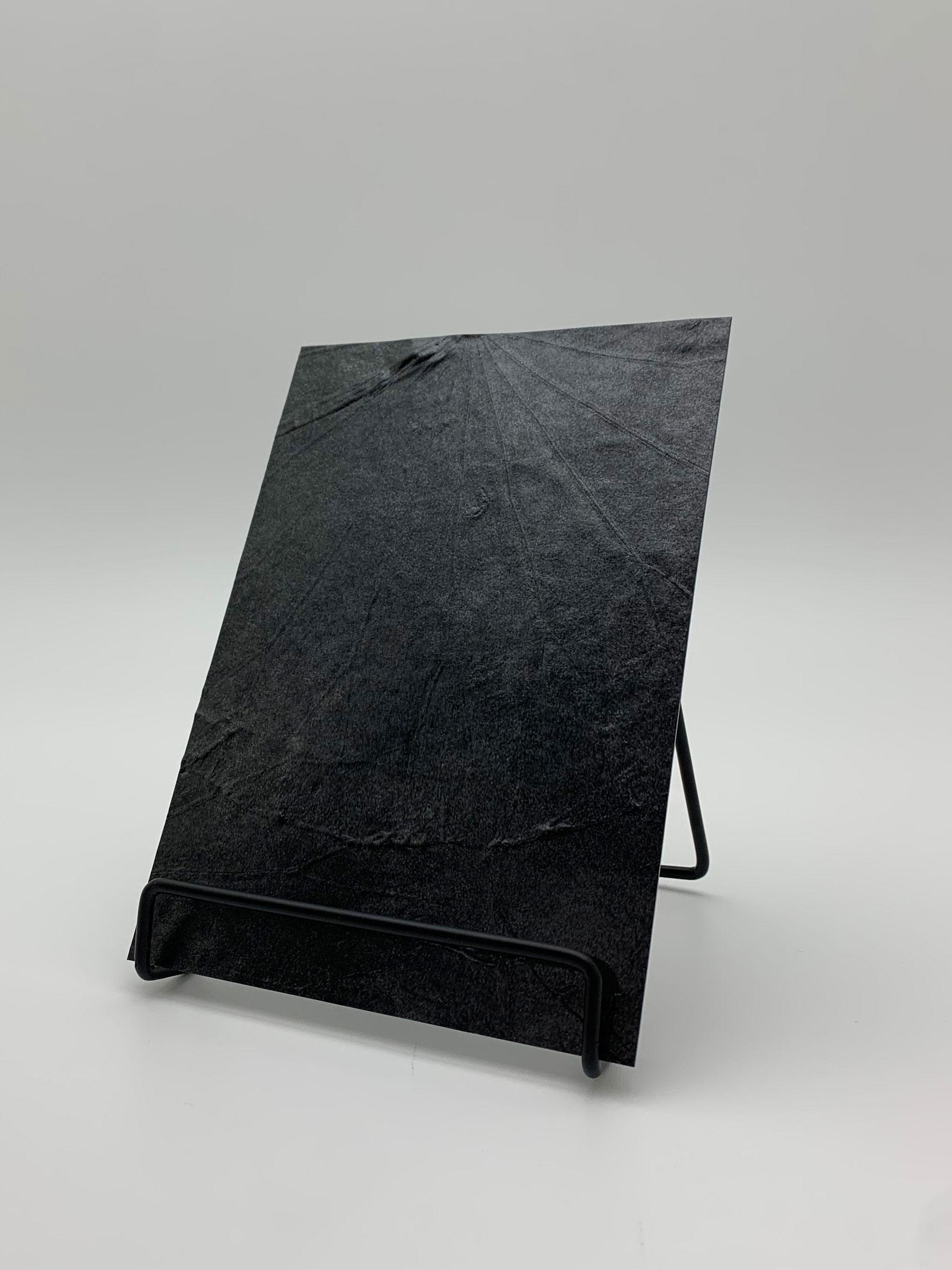 Elements Texture Iron Impact real material sample - a dented, hammered relief in iron black