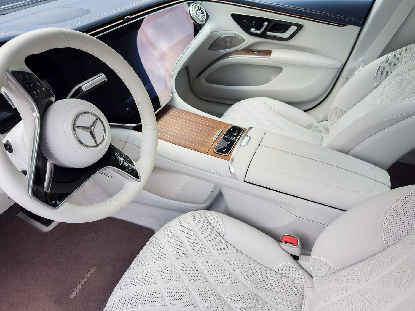 Koncepts striped wood inlay on the center console and door trim of a luxury car with an ivory leather interior