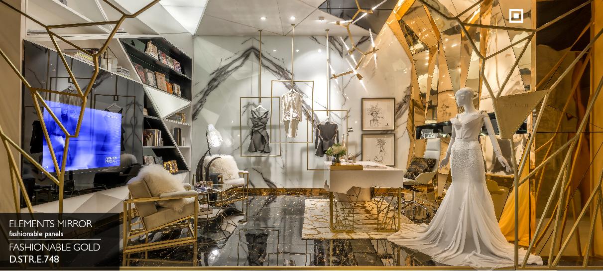 Elements Mirror Fashionable Gold angular panels cladding a fashion boutique wall behind a wedding dress mannequin