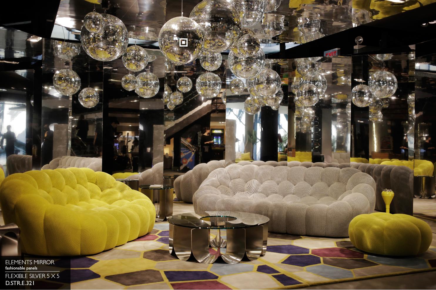 Elements Mirror Flexible Silver panel columns in a lounge with disco balls and yellow tufted sofas
