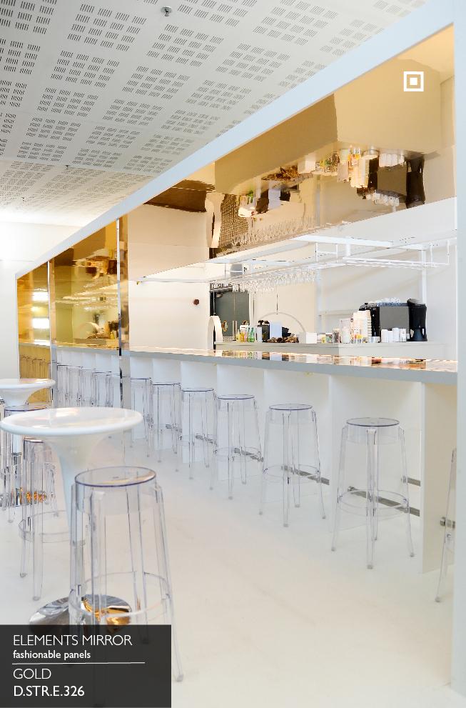 Elements Mirror Gold panel behind a bar counter with clear acrylic stools