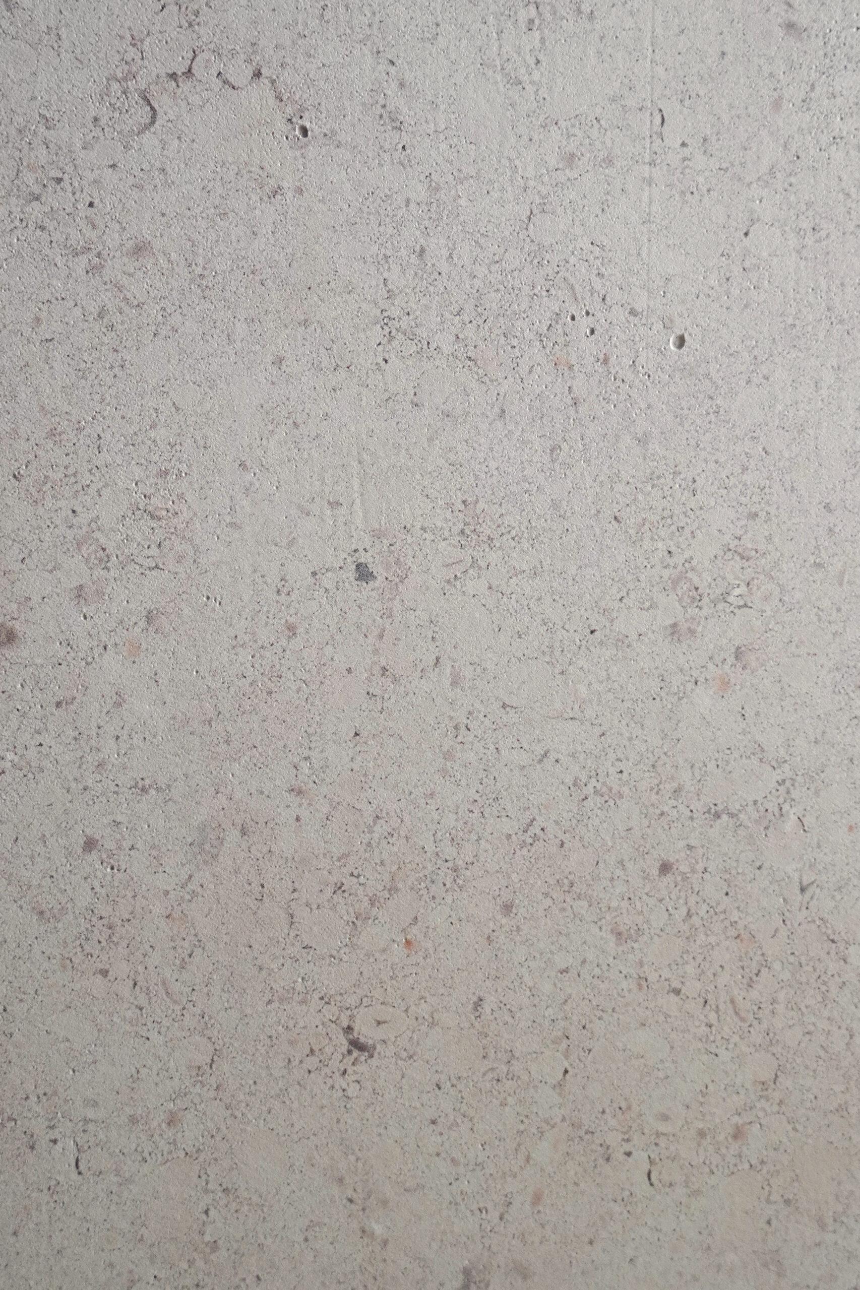 Aria Moon Cream real material sample - pale cream-grey concrete with fine speckling