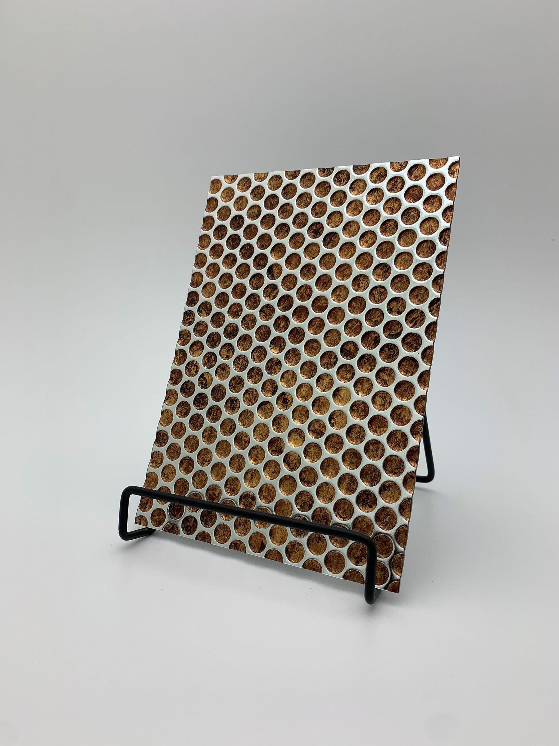 Elements Texture Punched Lava real material sample - copper lava texture behind a black punched-hole pattern