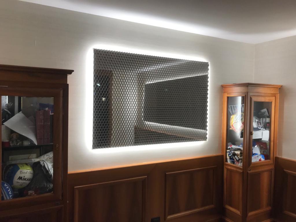 Backlit Luminous honeycomb mesh panel mounted as wall art in a residential living room
