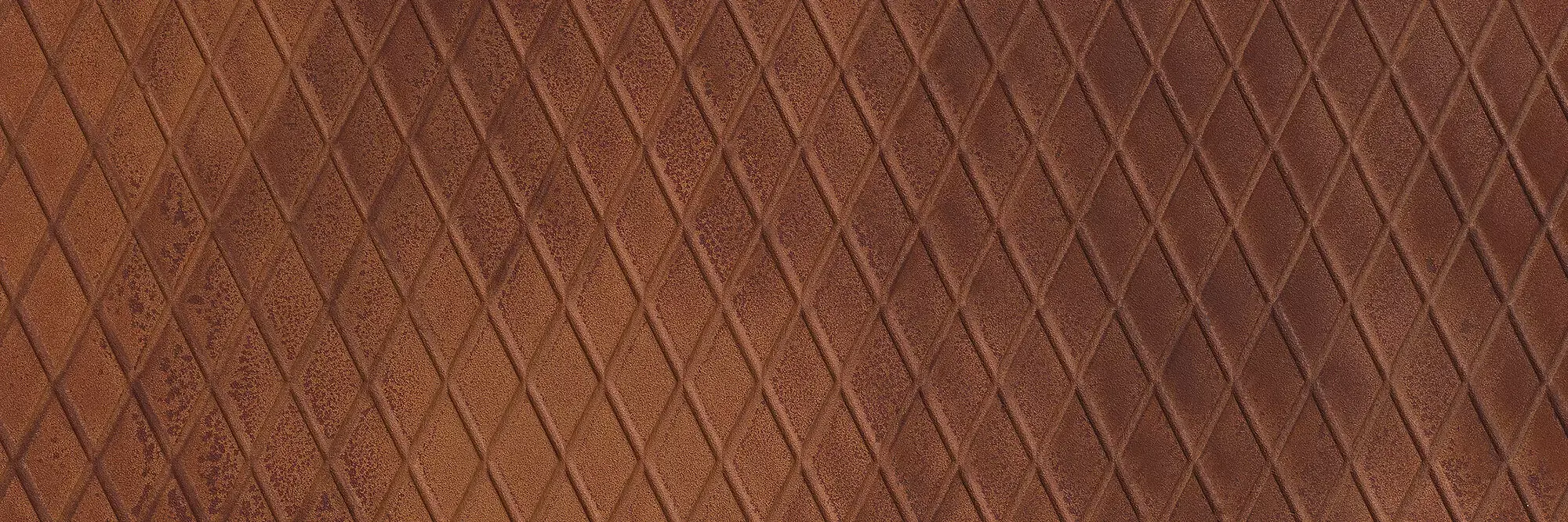 Aria Rust Rombi real material sample - oxidised rust with a raised diamond-plate pattern