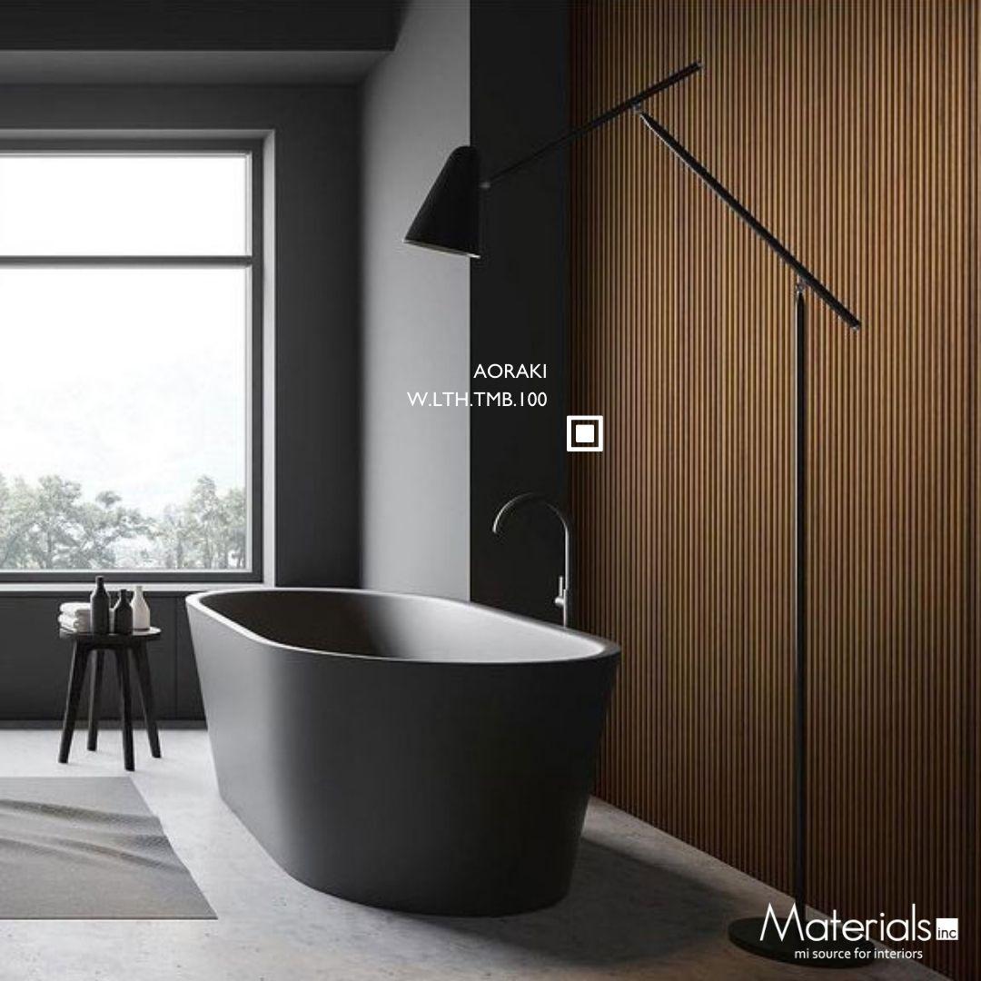 Tambora Aoraki milled wood panel as a feature wall behind a freestanding black bathtub