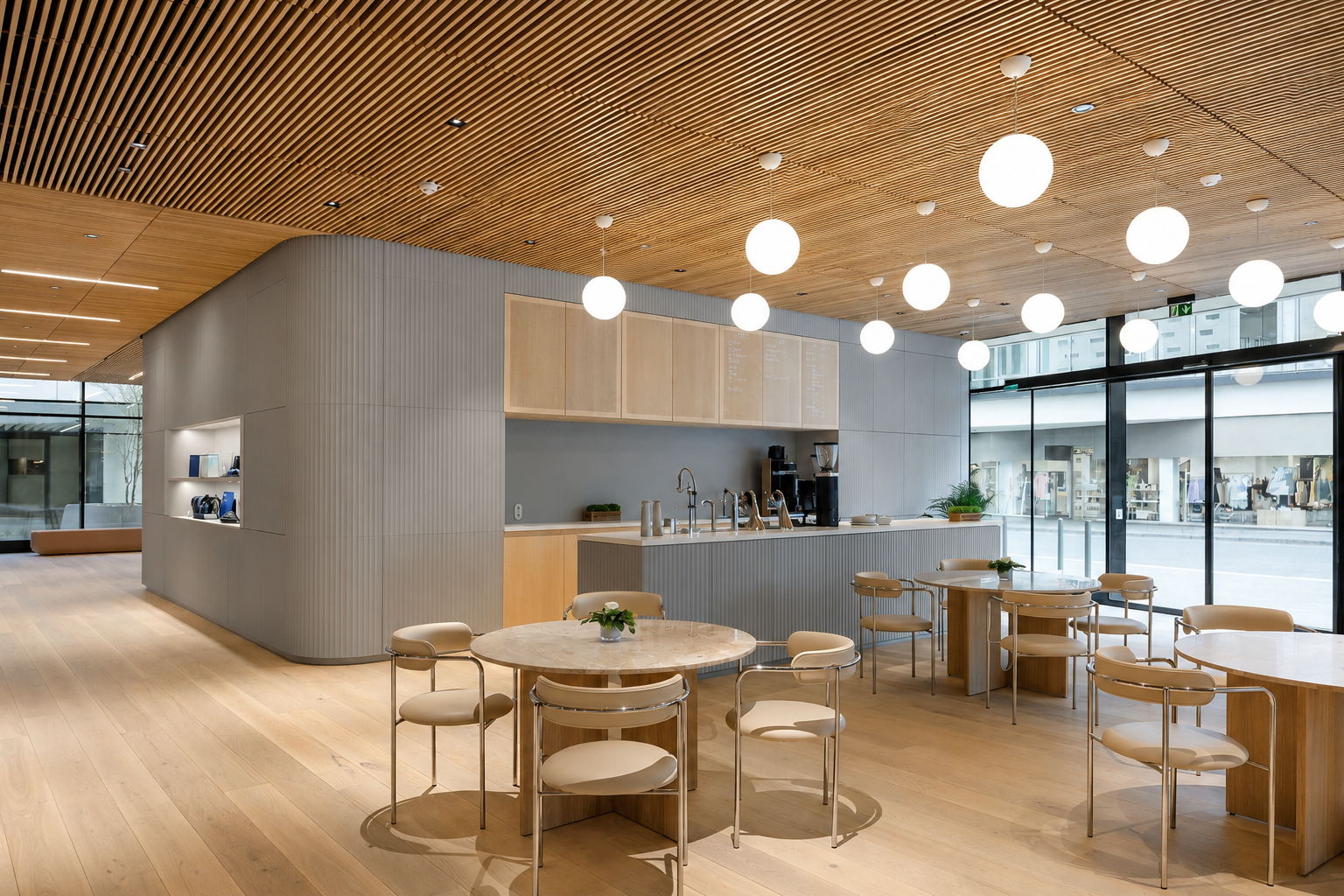 Café and retail space with a curved grey fluted concrete panel wall, wood slat ceiling, and round dining tables