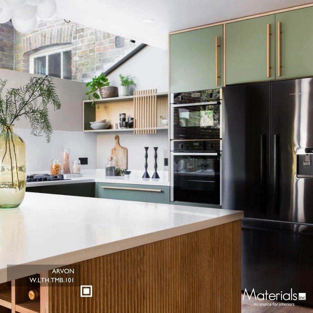 Tambora Arvon milled wood panel on a kitchen island front beside sage green cabinetry