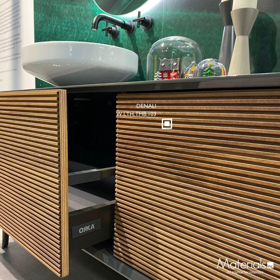 Tambora Denali milled wood panel on a bathroom vanity cabinet with a green tile backsplash