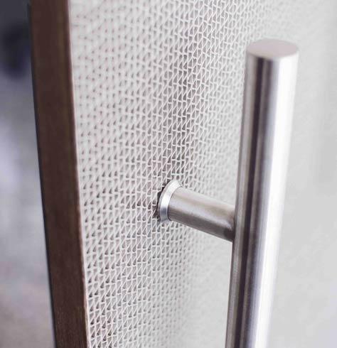 Ecowave translucent panel installed in a door with a steel pull handle - fine woven wave pattern