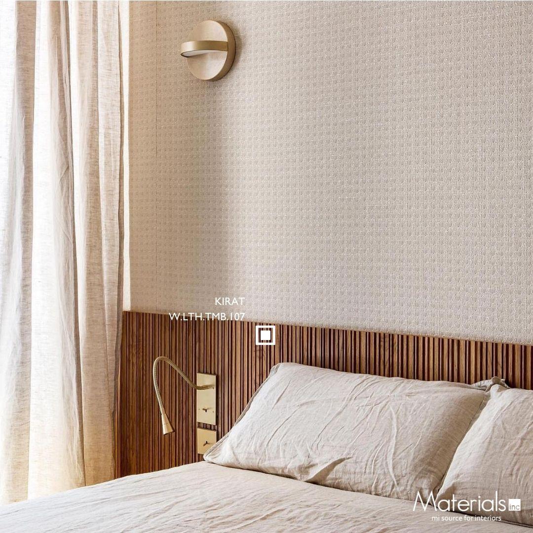 Tambora Kirat milled wood panel on a whitewashed bedroom headboard with a brass reading light