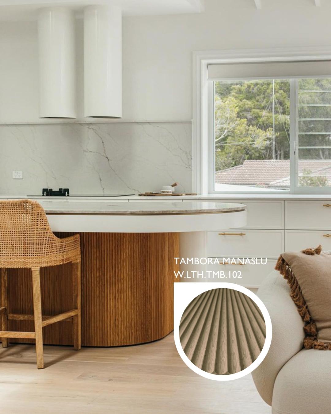 Tambora Manaslu milled wood panel on a round kitchen island base beside a rattan counter stool