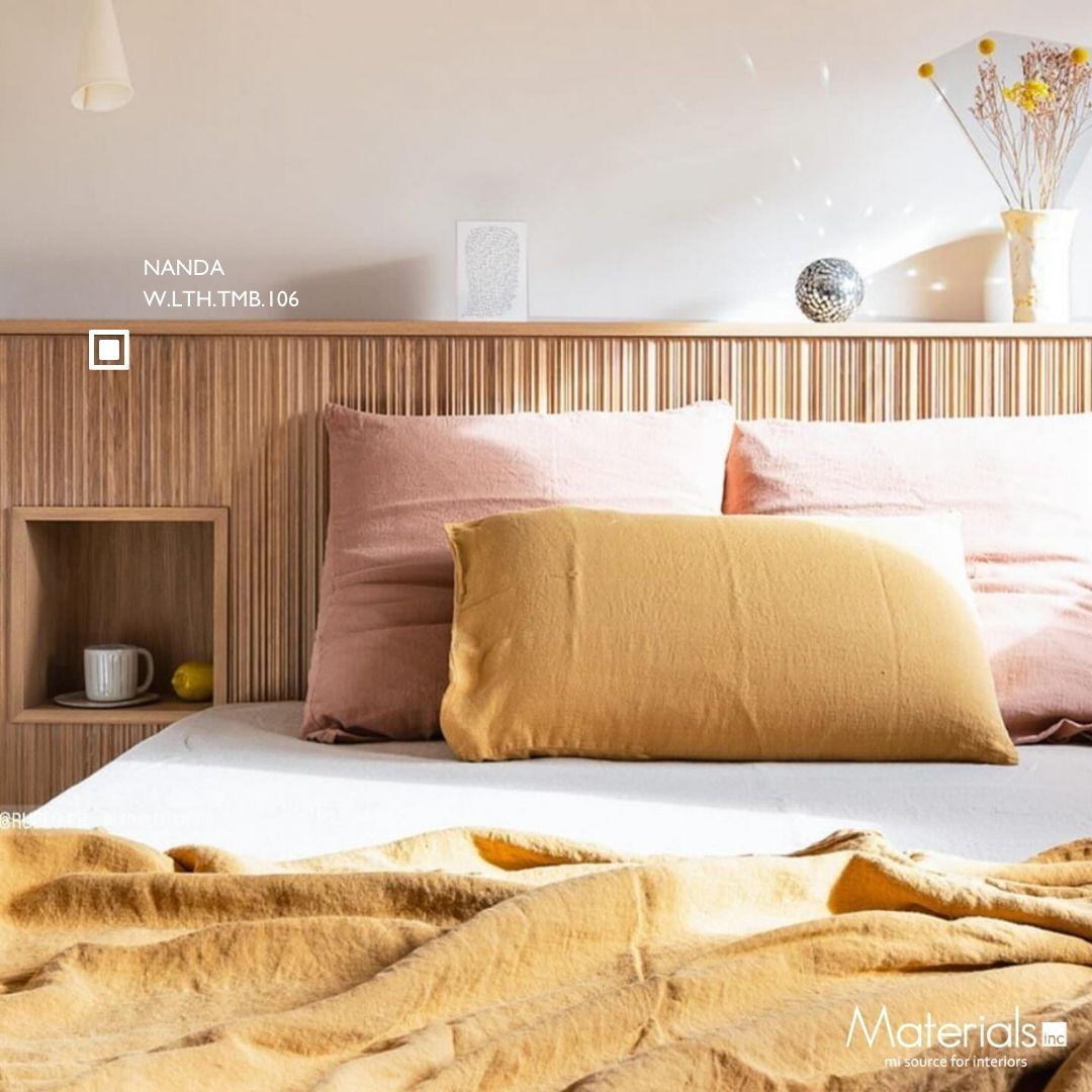 Tambora Nanda milled wood panel headboard with gold and blush pillows and a built-in nightstand nook
